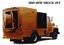 Yellow utility truck with a large hose reel mounted on the rear, labeled